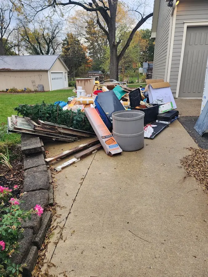 Dumpster being loaded with debris for Roofing Dumpster Rental in Southport